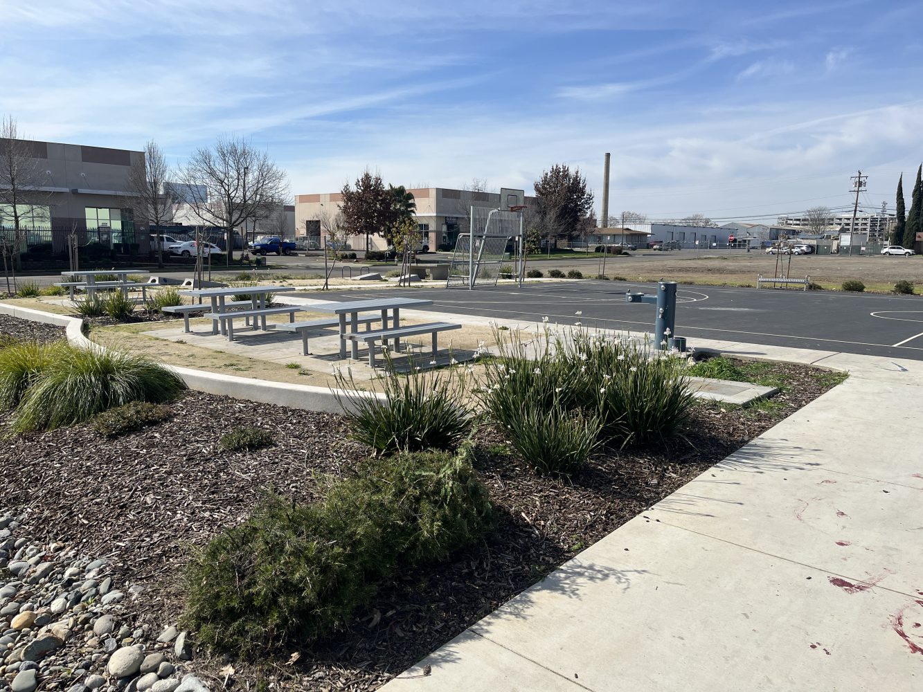 Picnic tables and water fountain at River District Park.