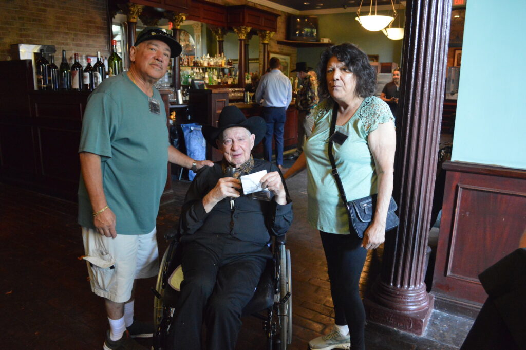 A photo of three individuals, including Henry Doering, pose for a photo at the Crest Carpets 55th Anniversary celebration.